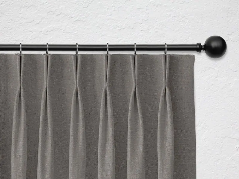 Dutch pleat curtain heading on a black rod