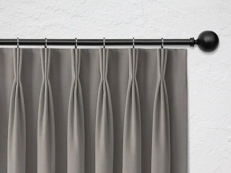 French pleat curtain heading on a black rod