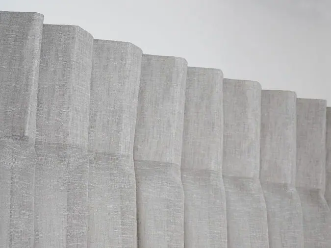 Inverted pleat curtain heading in a natural linen-look fabric