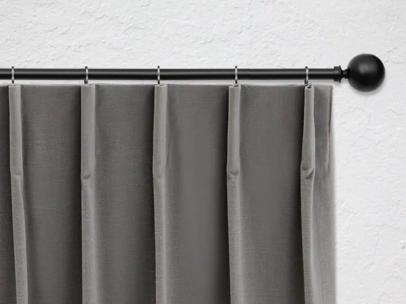 Single pleat curtain heading on a black rod