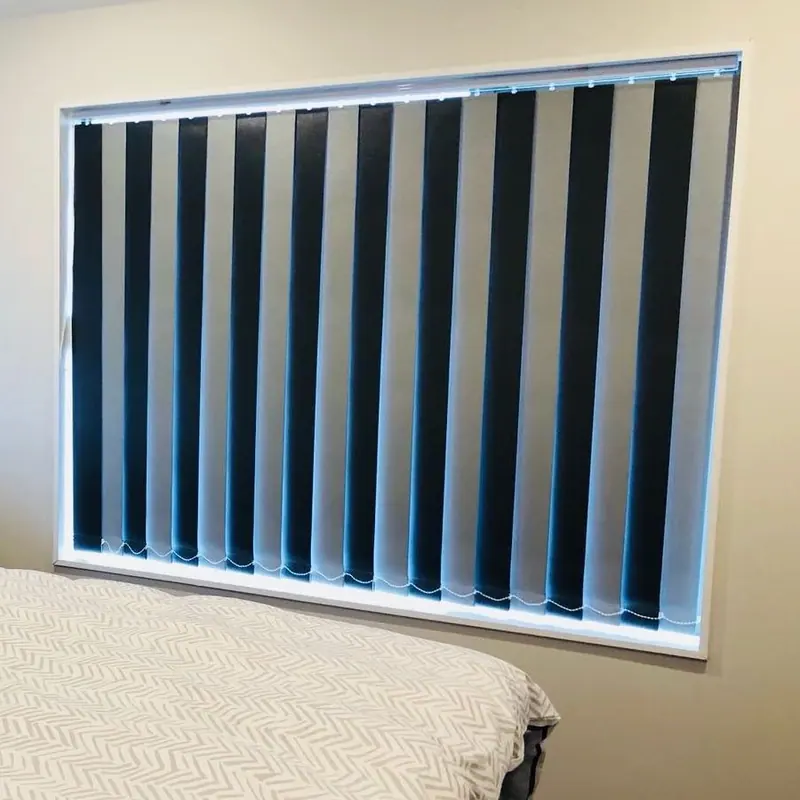 Black and white vertical blinds on a large bedroom window